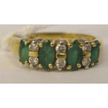 An 18ct gold four stone emerald and diamond ring