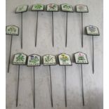 A set of twelve painted cast metal herb patch markers