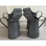 Two pairs of galvanised metal watering cans