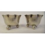 A pair of late Victorian silver salt cellars with crimped rims, on ball feet  Birmingham 1892