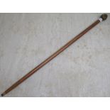 A turned mahogany walking cane with a cast brass four faced handle