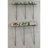 A set of six painted cast metal vegetable patch markers