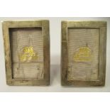 A pair of glazed silver photograph frames, on oak backs and easel stands  Birmingham 1915  3.75" x