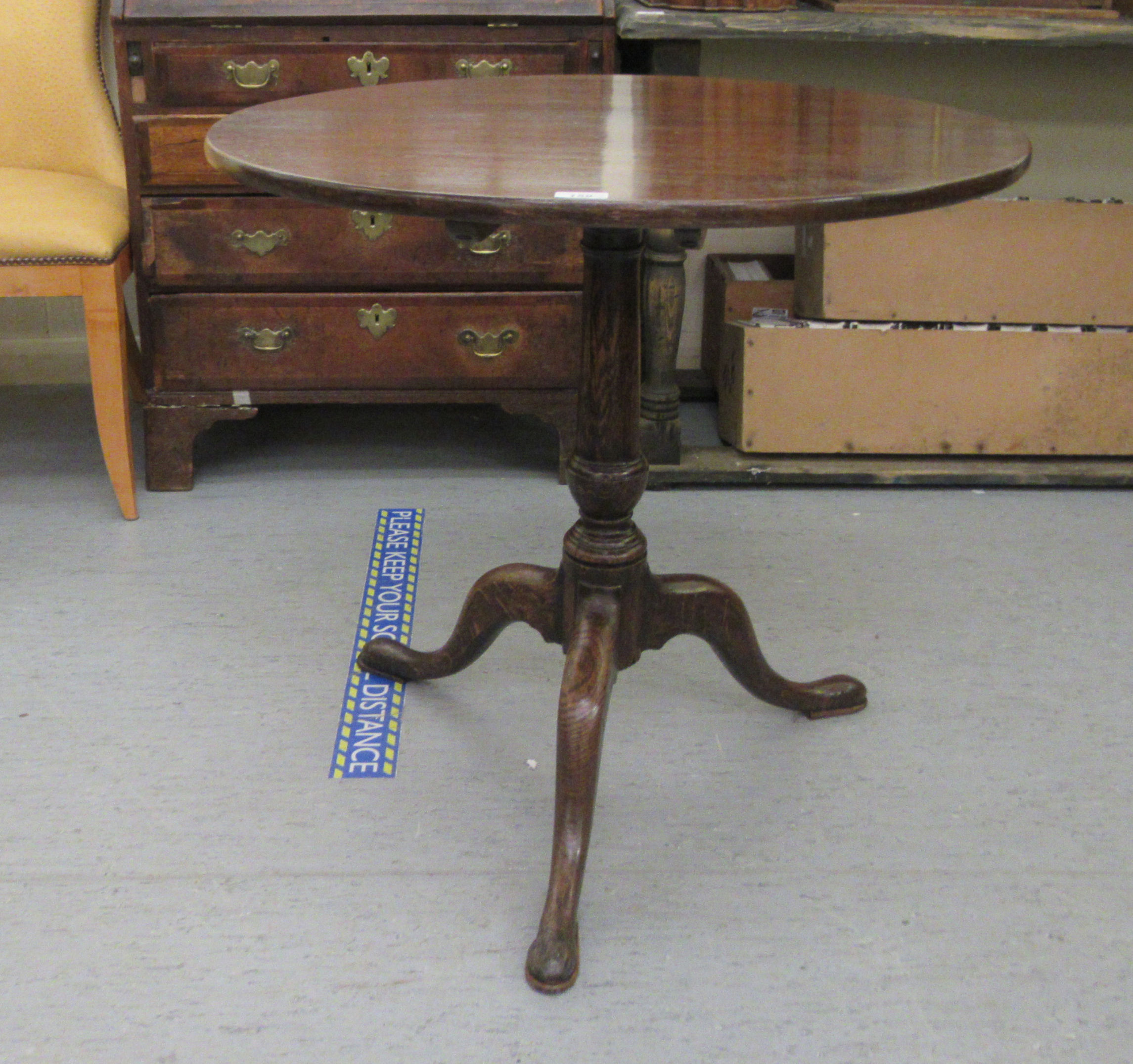 A George III and later oak pedestal table, raised on a cabriole tripod base  28"h  29"dia