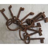 Three sets of antique style rust coloured cast iron keys