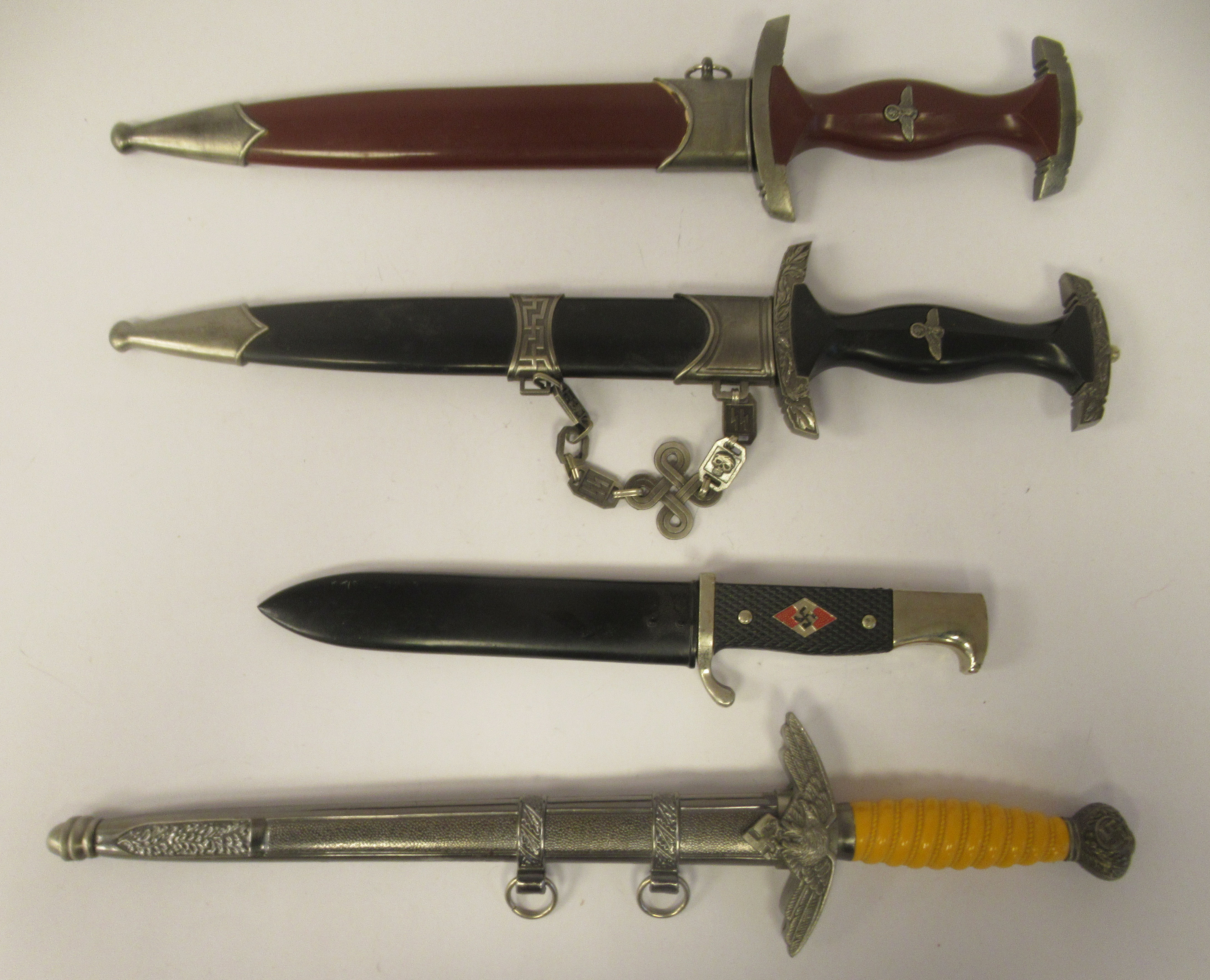 Four replica Third Reich era bladed weapons, viz. a Hitler Youth dagger, in a steel sheath; two