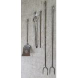 Early 20thC steel fire irons, viz. two long pokers; one short poker; tongs and a hearth shovel