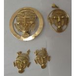 A suite of African gold coloured metal items of personal ornament, comprising a brooch, a pendant
