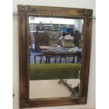 A modern antique inspired mirror, the bevelled plate, set in a moulded gilt frame  19" x 29"