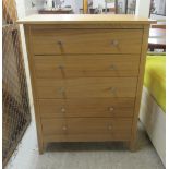 A modern light oak finished five drawer dressing chest, raised on block feet  40"h  33"w