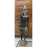 A carved ebonised figure, an African man  47"h