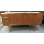 A McIntosh teak sideboard with a bank of three offset drawers and a pair of cupboard doors, raised