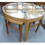 A 1970s Nathan teak Trinity table 20"h 32"dia over three lozenge shaped tables 18"h 23"dia