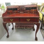 A 20thC reproduction of a Georgian mahogany bureau, the open front with an arrangement of drawers