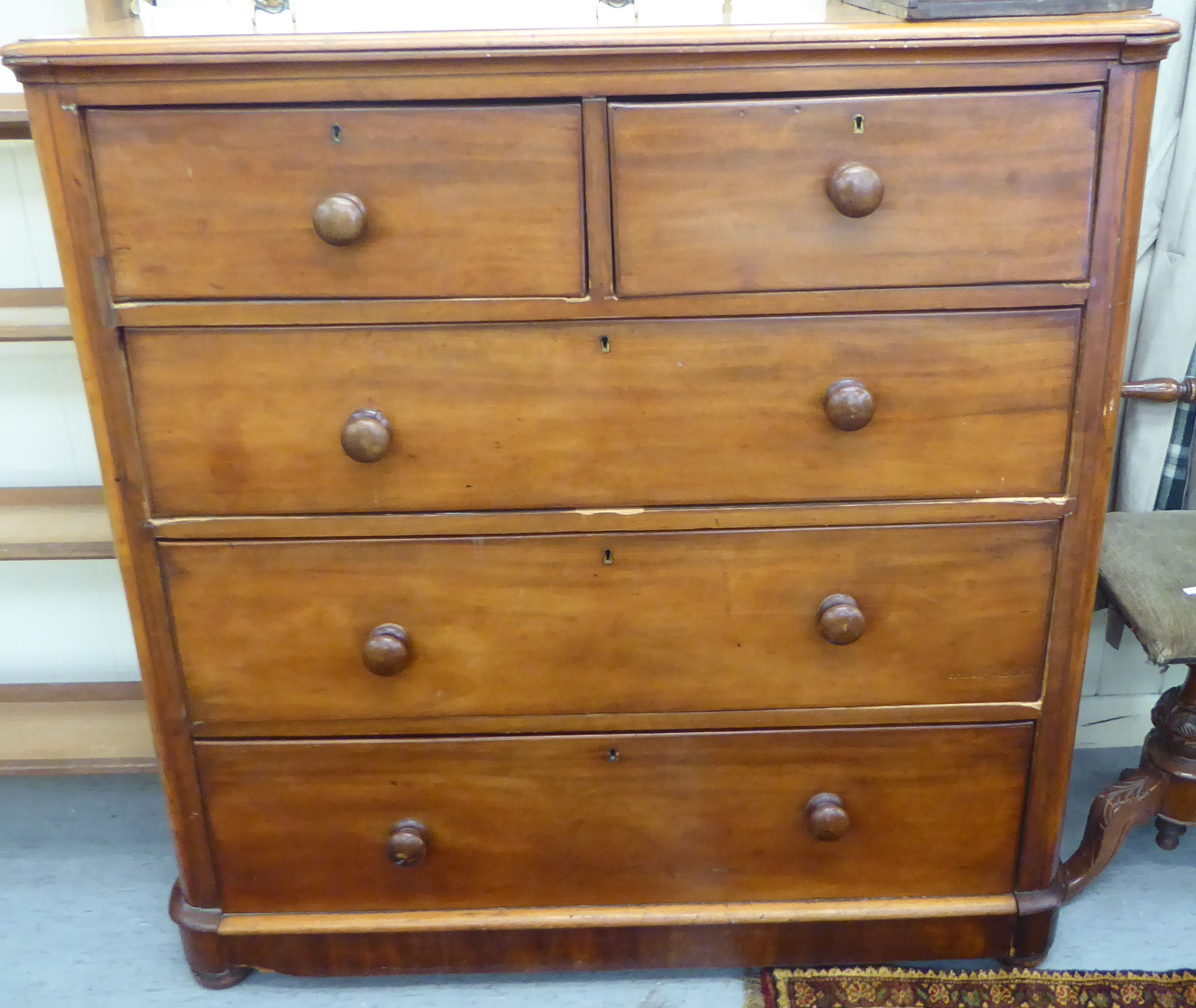 A late Victorian mahogany dressing chest, having round corners, comprising two short/three graduated