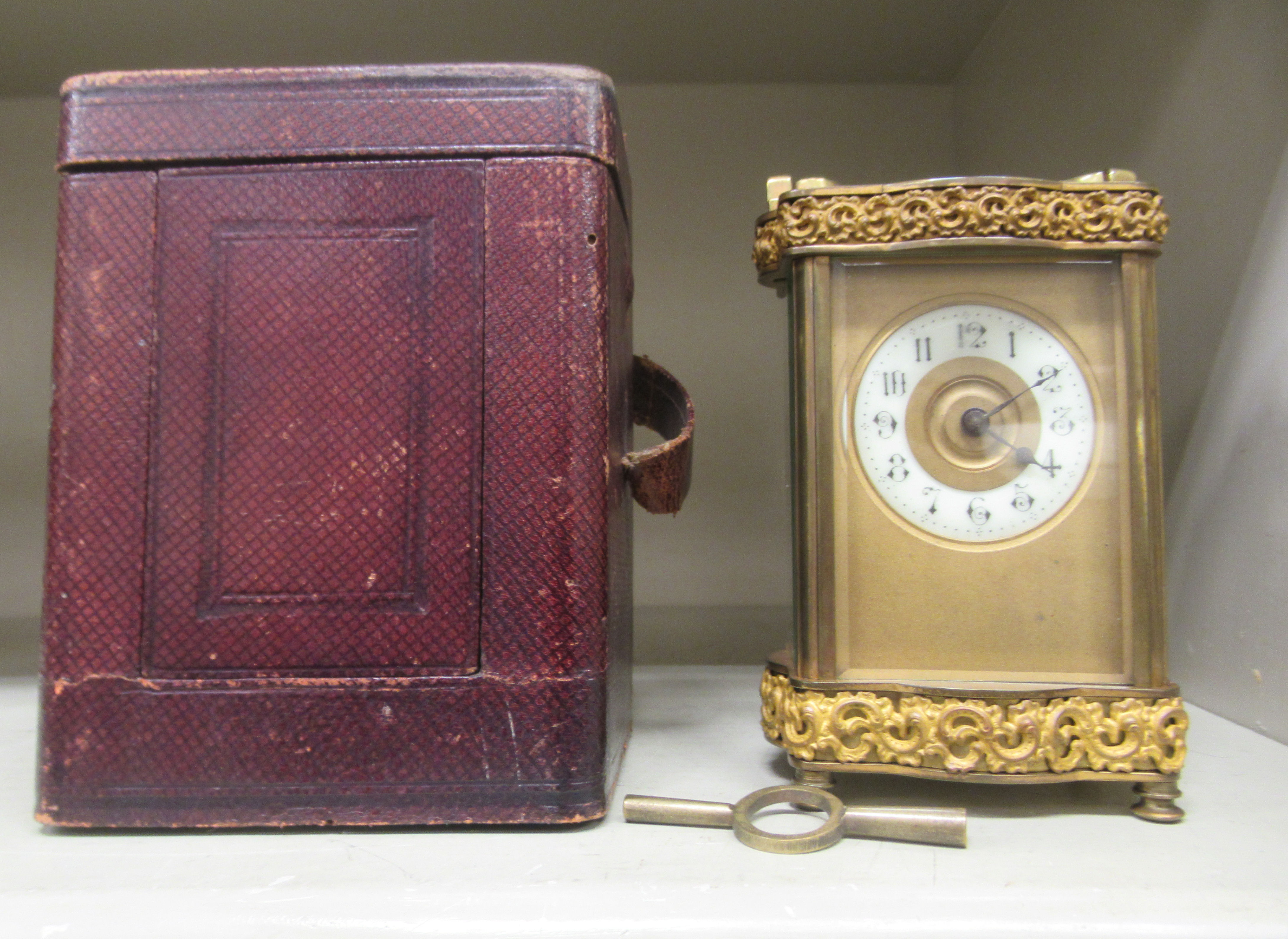 An early 20thC serpentine outlined brass cased carriage timepiece with decoratively cast borders, - Image 5 of 5