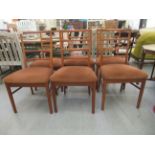 A set of six 1970s teak framed quadruple bar back dining chairs the fabric covered seats raised on
