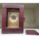 An early 20thC serpentine outlined brass cased carriage timepiece with decoratively cast borders,