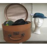 Five various ladies hats, in a contemporary piece of luggage and a moulded polystyrene model head