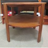 A 1920s oak two tier occasional table, raised on block legs  20"h  24"dia