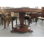 An early Victorian mahogany breakfast table, raised on an octagonal, tapered column and a splayed