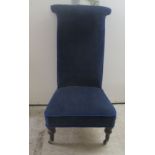 An early 20thC prie dieu, the later, Royal blue fabric upholstered back and seat raised on turned