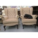 A pair of modern part button upholstered wingback armchairs, raised on cabriole forelegs