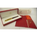 A Must de Cartier Stylos fountain pen with a maroon lacquered and plated body, a threaded connection