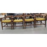 A set of four modern beech framed open arm chairs, the fabric covered seats raised on block forelegs