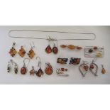 Modern silver and amber set earrings, pendants and brooches