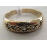 A 9ct gold gypsy design ring, set with five diamonds