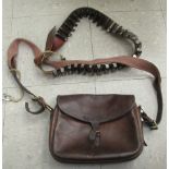 An early 20thC brown hide satchel and a shotgun cartridge belt