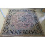 A Persian Kashan rug, decorated with stylised floral designs, on a mainly pink ground  82" x 78"