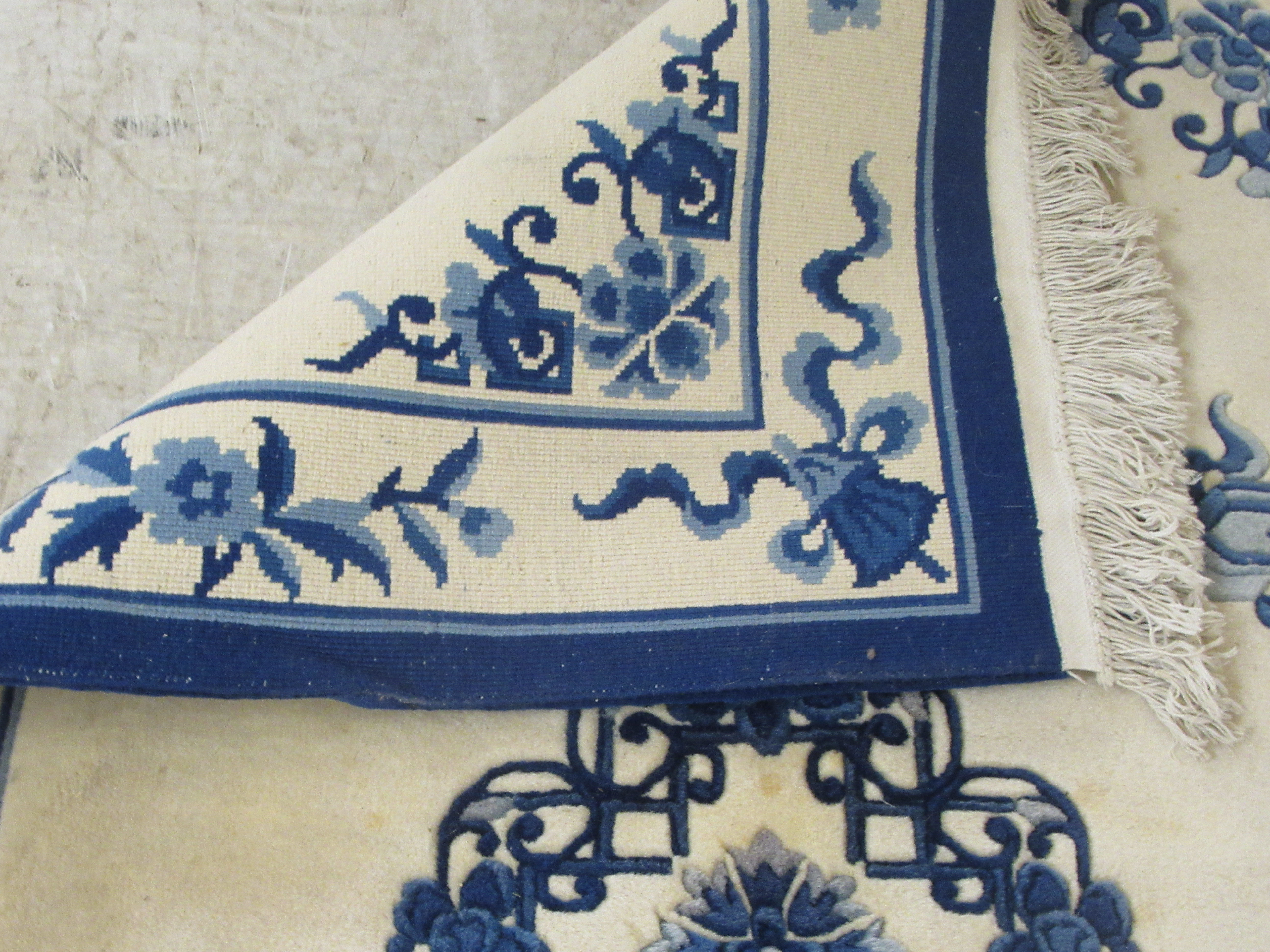 A modern Chinese washed woollen rug, traditionally decorated on a blue and white ground  48" x 76" - Image 5 of 5