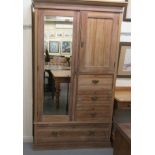 A late Victorian satin walnut compactum, comprising a three quarter height mirrored door, a single