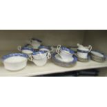 Aynsley bone china teaware, decorated with blue flora and highlighted in gilt