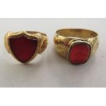 An 18ct gold shield shaped signet rings and another gold coloured metal seal ring