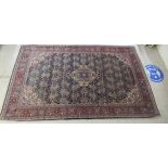 A Persian rug, profusely decorated with repeating stylised designs on a multi-coloured ground  85" x