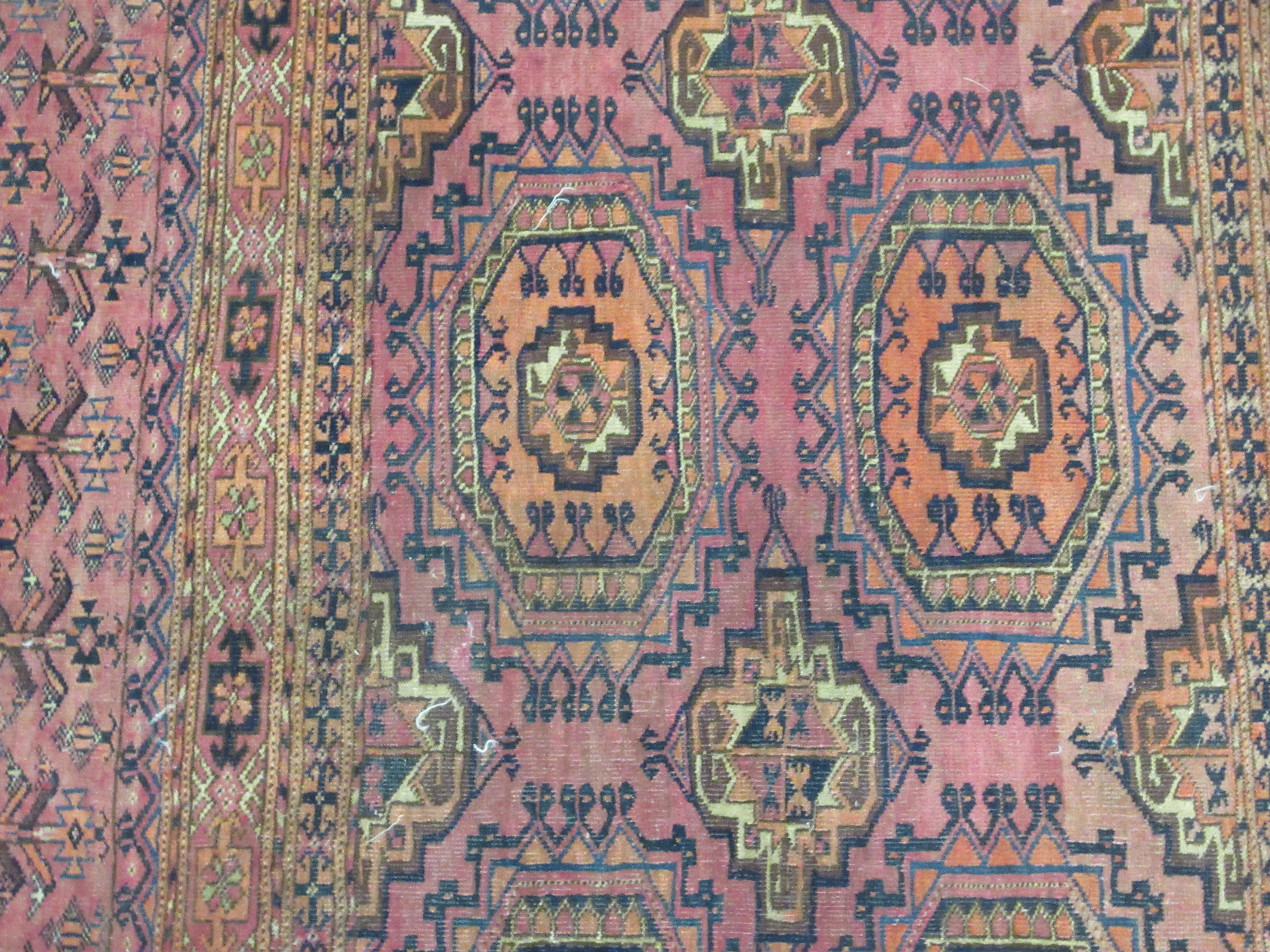 A Bokhara rug, decorated with two columns of four octagonal motifs, on a red ground  29" x 47" - Image 2 of 5