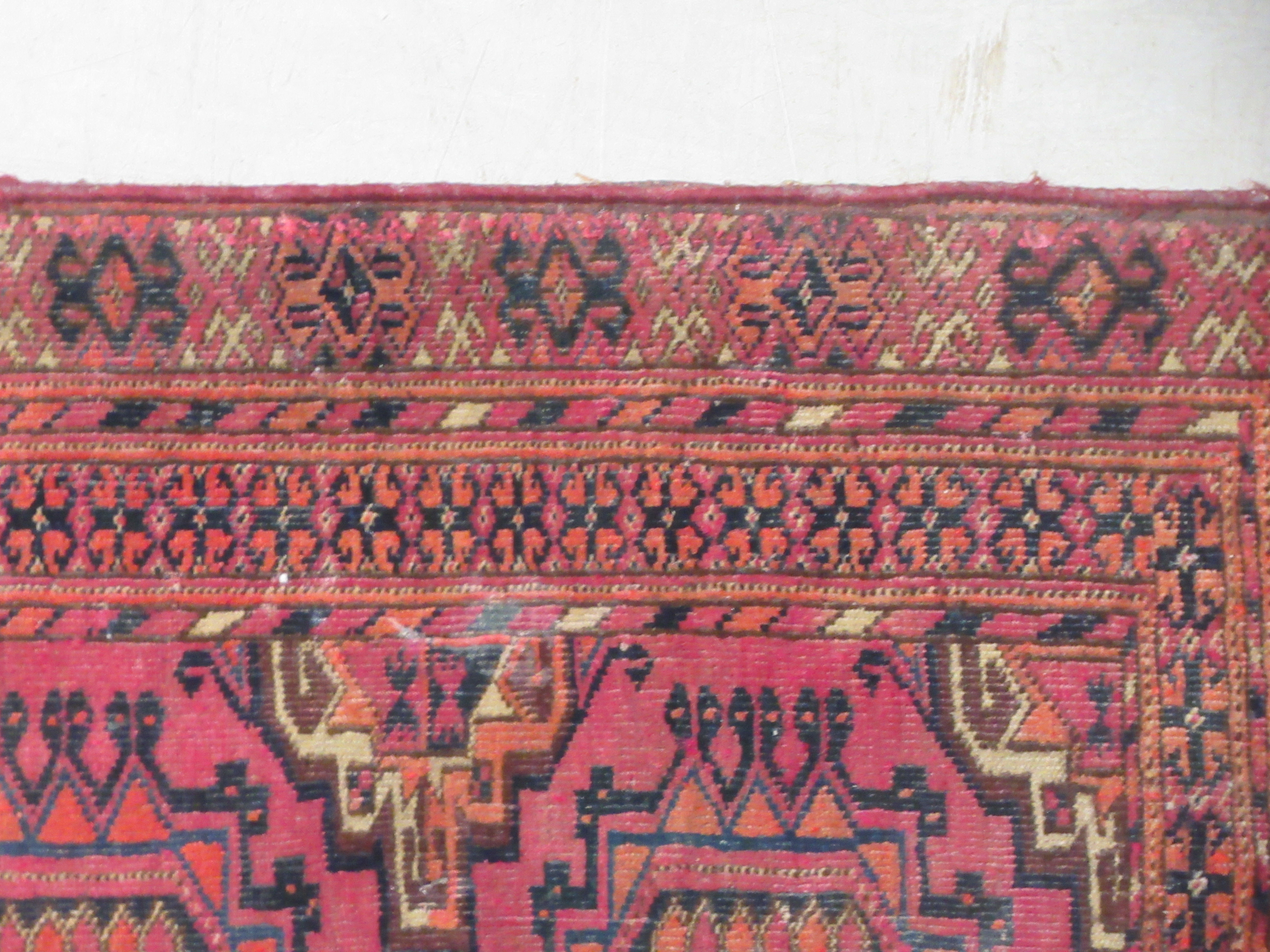 A Bokhara rug, decorated with two columns of four octagonal motifs, on a red ground  29" x 47" - Image 4 of 5