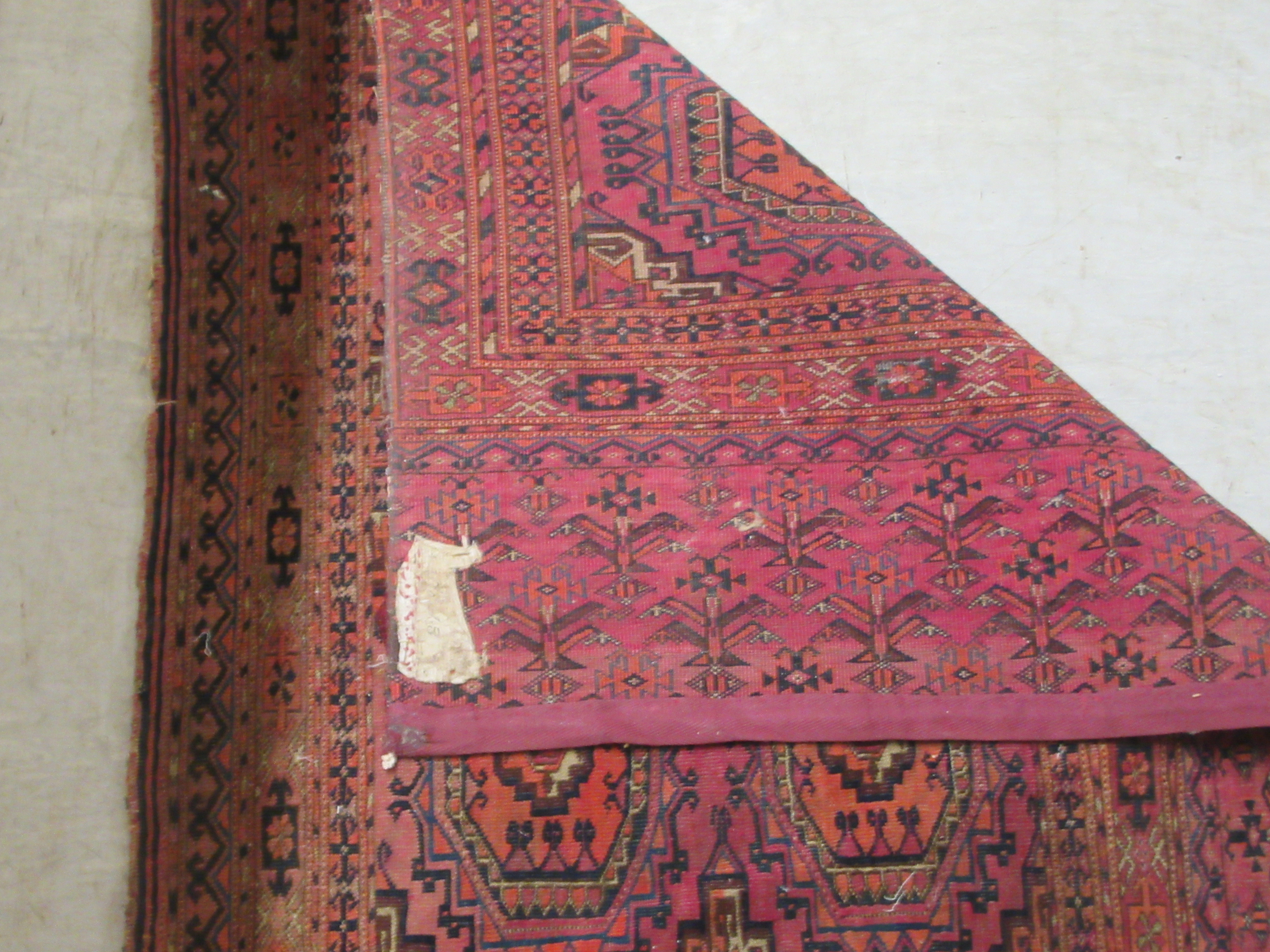 A Bokhara rug, decorated with two columns of four octagonal motifs, on a red ground  29" x 47" - Image 5 of 5