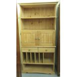 A modern pine kitchen unit with two drawers, over an open divided section, on a plinth  33"h  38"w