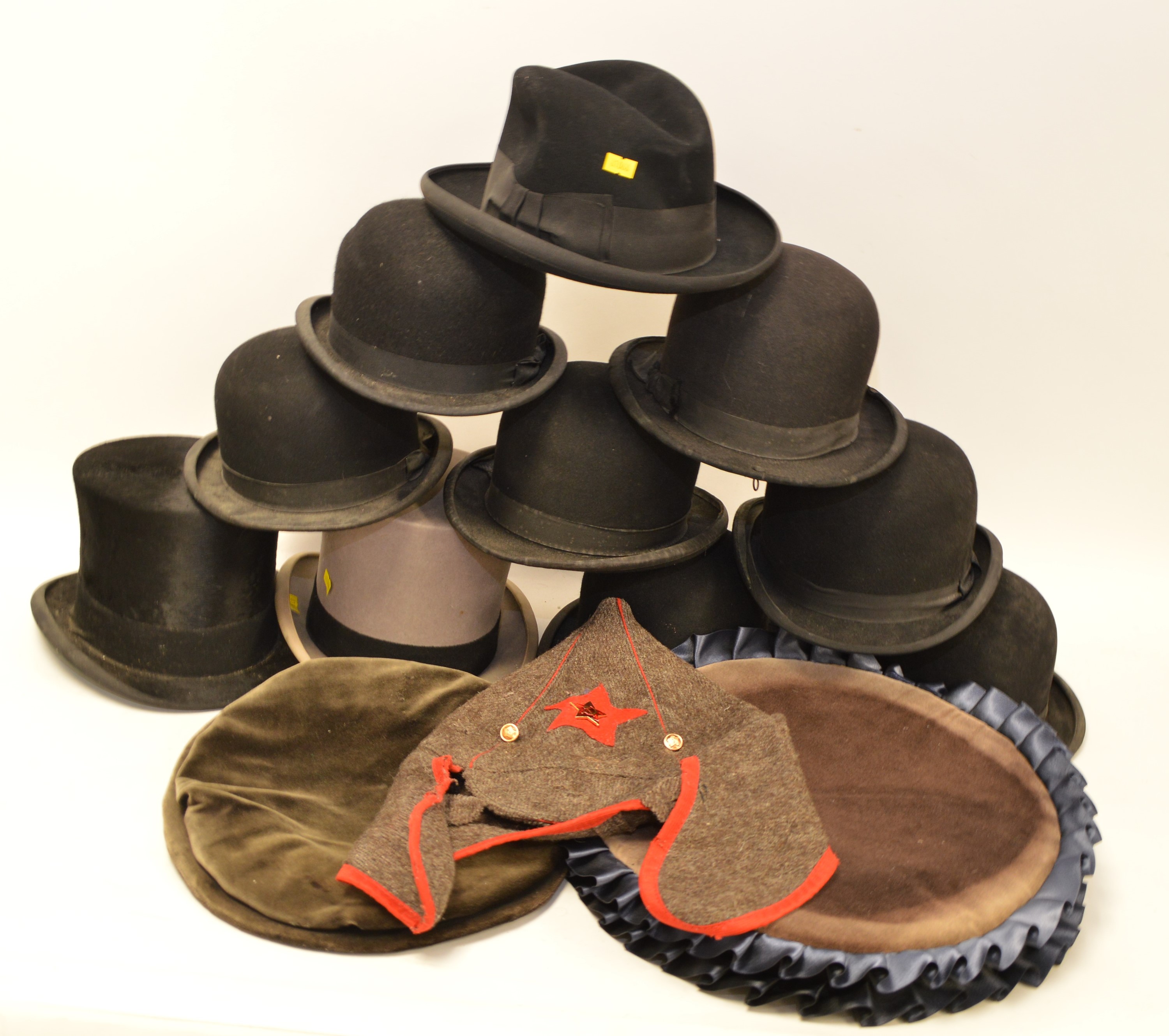 A collection of vintage top, bowler and other hats.