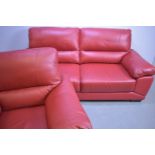 Red leather two-seater sofa and matching armchair.