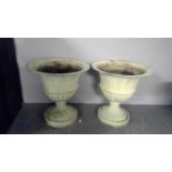 A pair of cast metal urns,