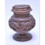 A Chinese carved wooden tobacco jar with white metal liner.