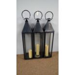 Three patinated metal lanterns