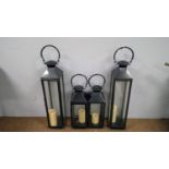 Two pairs of patinated metal lanterns