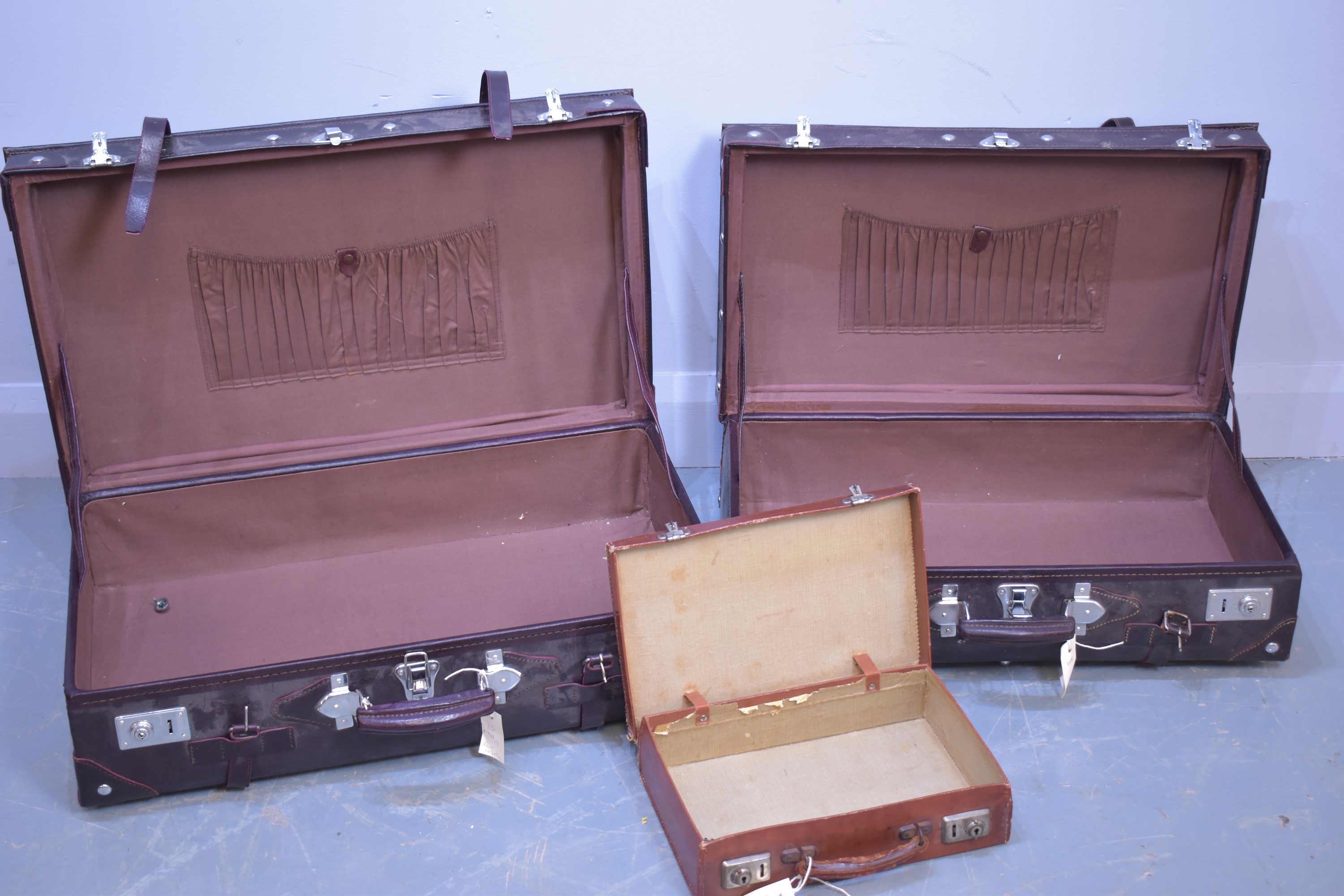 Two suitcases; and an attache case.