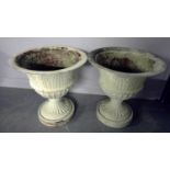 A pair of cast metal urns,